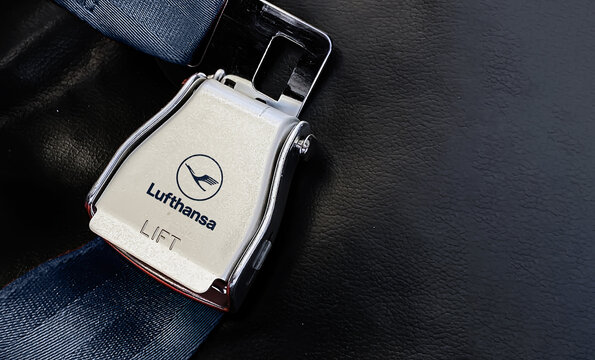 airplane passenger seat safety belt with the Lufthansa logo printed on the metal