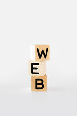 Cubic wooden blocks forming the 'web' text