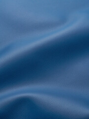 close up of blue artificial leather with waves and folds on PVC base