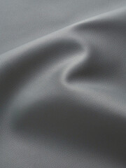 close up of grey artificial leather with waves and folds on PVC base