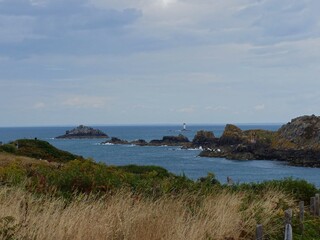La pointe du Groin, France - August 2018 : Hike around the pointe du Groin in Brittany with the passage of a beautiful sailboat in the English Channel