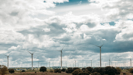 large wind farm over cloudy sky
