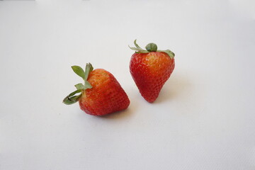 Two Red Strawberries on White Canvas Background
