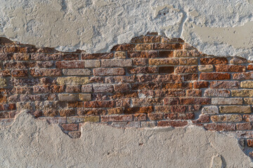 old wall with exposed bricks background 
