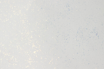 Background texture of white paper with glitter.