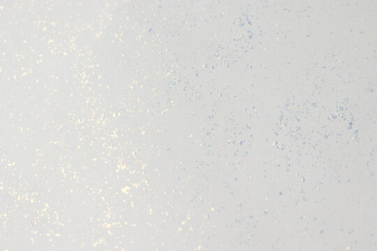 Background texture of white paper with glitter.