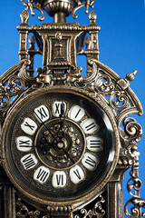 dial of vintage bronze clock, antique clock photo close up, old bronze clock in gilding, front of bronze fireplace clock vertical photo