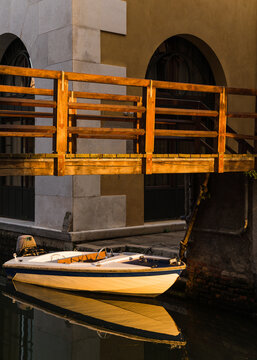 old wooden bridge and boat in Venice, Italy 