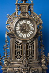 dial of vintage bronze clock, antique clock photo close up, old bronze clock in gilding, front of bronze fireplace clock
