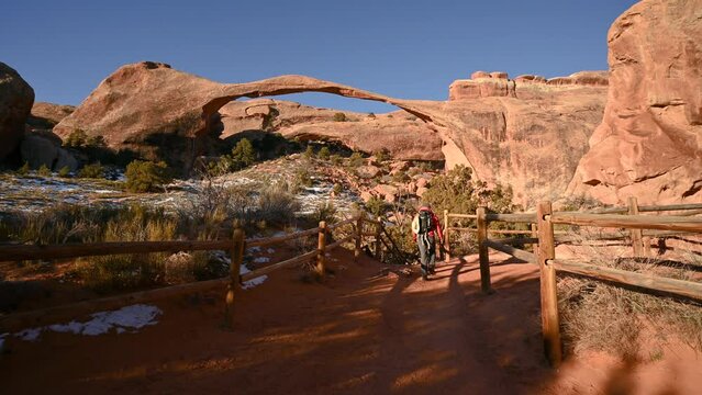 Hiker near Landscape Arch, a scenic destination inside of Arches National Park, Utah