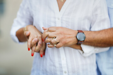 Cute middle aged european couple hugging , hands close up