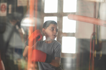 boy training hard in the gym to be a winner. concept of discipline and courage