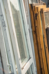 Old wooden window frames with dirty glass. Renovation in room in retro style. Preparation for disposal of box openings.