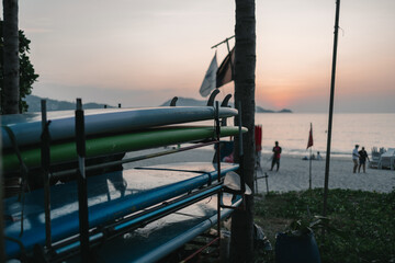 Sunset light hitting a set of surf boards in Patong Beach, Phuket, Thailand