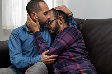 Real couple of Latin American men share relationship with affection. They embrace with love. Concept of sexual diversity