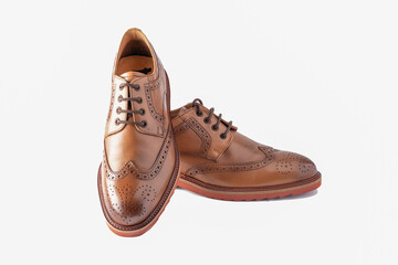 Pair of elegant men's shoes in brown leather, isolated on a white background
