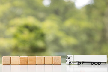 Top view of toy truck with boxes on green background. Logistics and wholesale concept