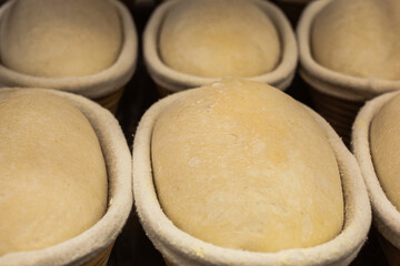 The baker holds in his hands molds for making molded bread. Working mood.