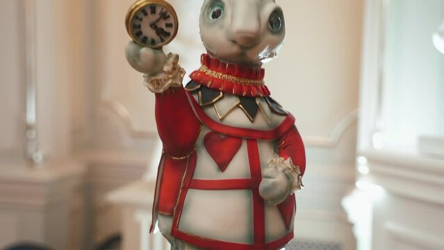 Nice Decorative composition, a festive decoration for Easter. Decorative figure of the rabbit with clock in hands. Alice in wonderland concept. nice and kind. High quality FullHD footage