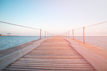 Fototapeta na wymiar Wooden pier near the blue sea.