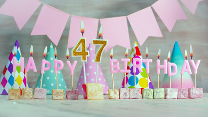 Happy birthday number  47 in pink pastel colors for a girl or woman. Happy birthday greeting card.