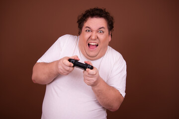 Funny fat man plays a video game.	