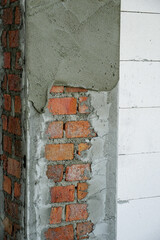 Mon or clay brick wall and the wall is currently being plastered.                       