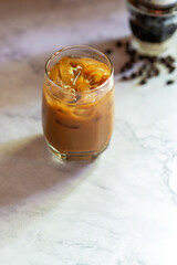 Vietnamese iced coffee, dark roast coffee brewing with sweet condensed milk in glass