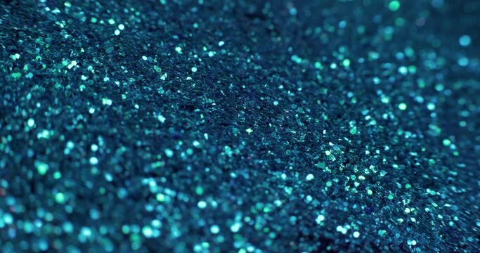 Glitter paint fluid. Volcano dust. Defocused golden sequin glow on dark blue liquid flow background shot on RED Cinema camera.