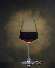 A glass of red wine and almonds