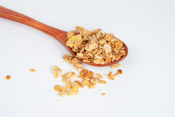 Oatmeal cereal breakfast in wooden spoon isolated on the white background