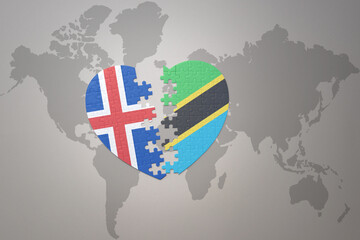 puzzle heart with the national flag of tanzania and iceland on a world map background. Concept.