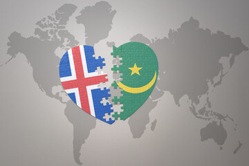 puzzle heart with the national flag of mauritania and iceland on a world map background. Concept.