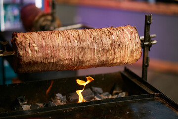 Doner Kebab On Rotating Spit. Traditional Turkish food Doner Kebab. Turnspit skewing kebap or kebab...
