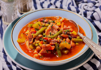 Bacon and vegetable soup with herbs and spices.
