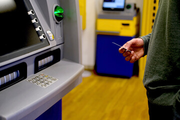 close-up of male hand takes euro banknotes from ATM machine, young man count euro banknotes of eu,...