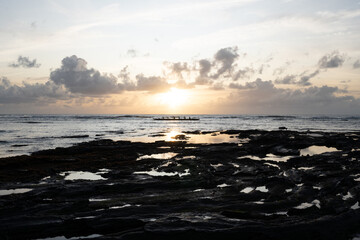Reflection of sea water on the beach with low tide and exposed rocks