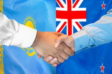 Handshake on Kazakhstan and New Zealand flag background. Support concept