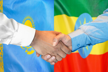 Handshake on Kazakhstan and Ethiopia flag background. Support concept