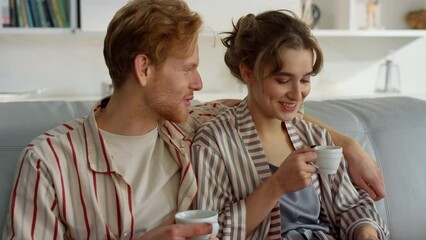 Joyful lovers watching laptop on comfy couch closeup. Romantic couple in morning