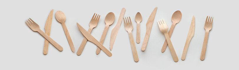 Wooden eco-friendly cutlery lies in a row, isolated