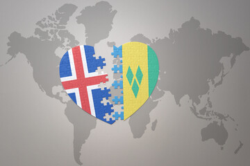 puzzle heart with the national flag of saint vincent and the grenadines and iceland on a world map...