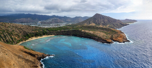 Fototapeta na wymiar Aerial drone view of famous Hanauma Bay and its beach with koko Head Crater in the background. The beach is known for snorkeling.