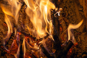 Bright flame of a burning fire in the dark