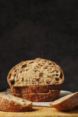 Artisan bread loaf with added grains, sliced loaf, vertical frame. Healthy bread from the bakery