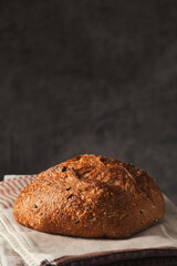 Healthy bakery bread, loaf of artisan grain bread on the table, vertical frame
