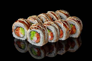 Sushi roll with smoked eel, avocado and cream cheese on black background. Sushi menu. Japanese food.