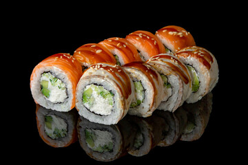 Sushi roll mix with salmon and smoked eel, avocado and cheese on black background. Sushi menu. Japanese food.