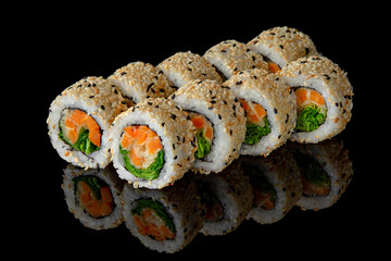 Sushi roll vegetarian with baked carrots and chuka salad on black background. Sushi menu. Japanese food.