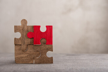 Creative idea and solve the problem concept. Teamwork success strategy - wooden puzzle on the grey...